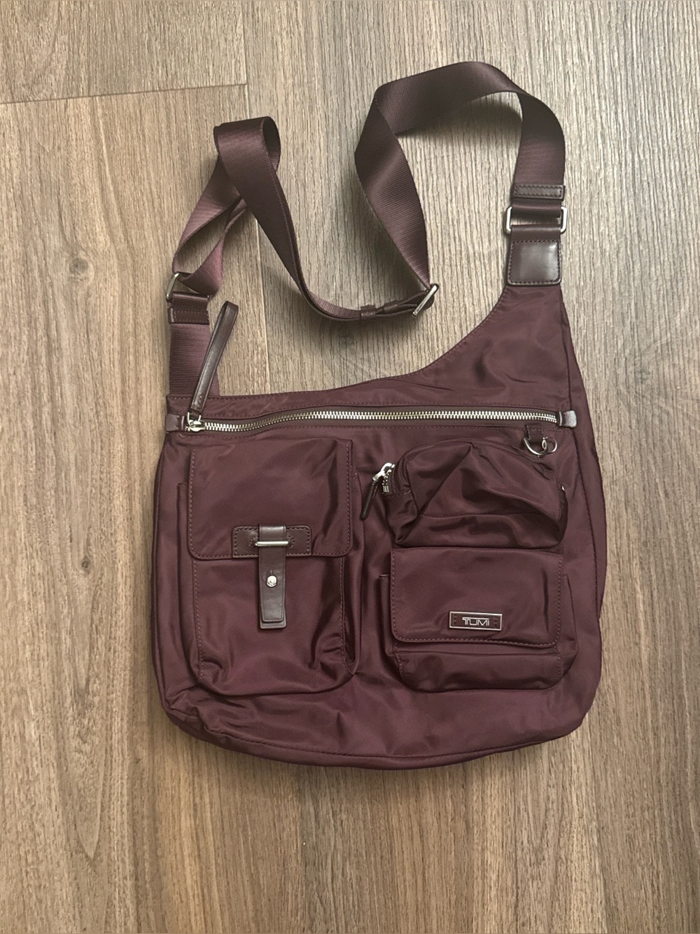 Tumi voyage series maroon Sumatra crossbody bag.
